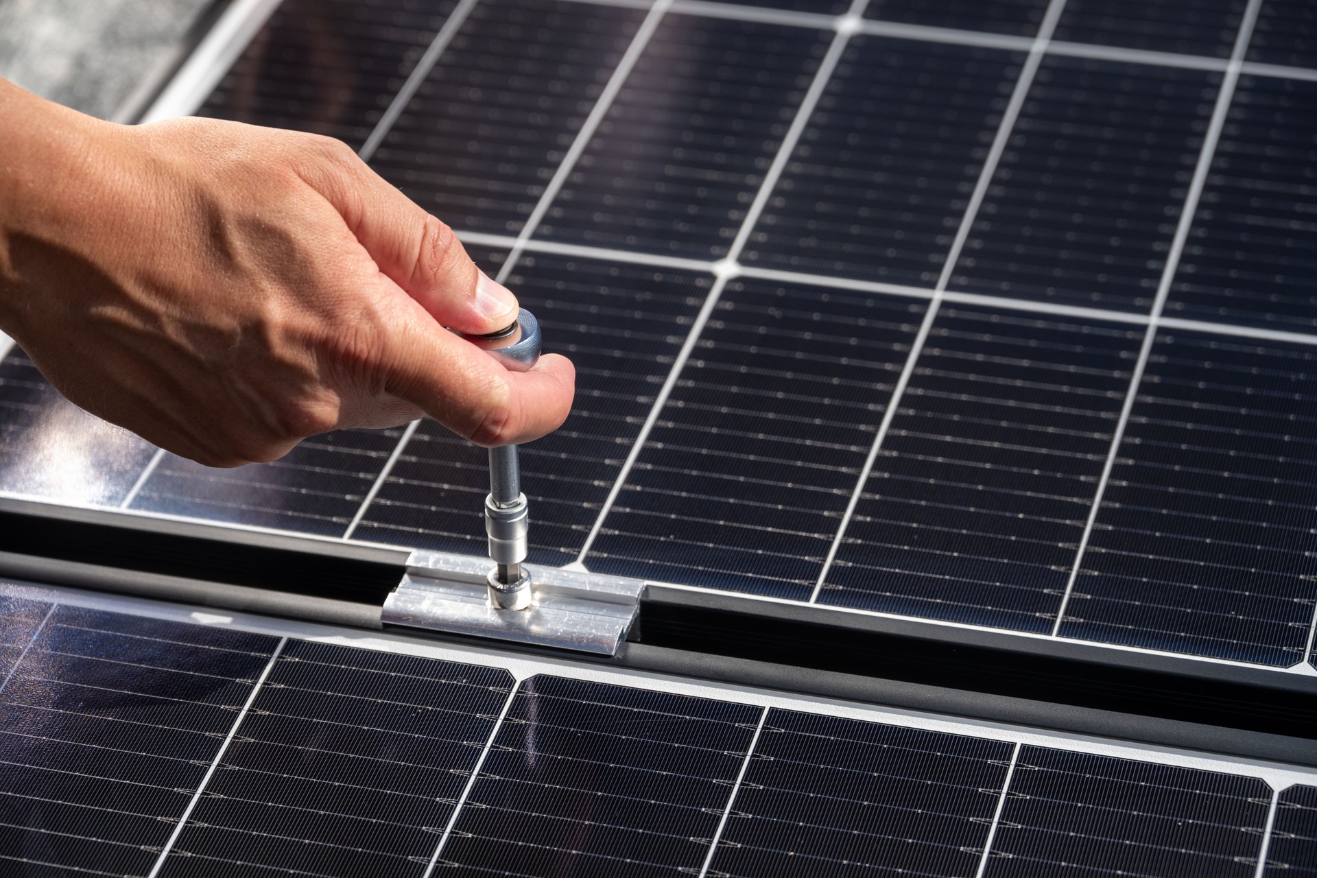 Adjusting Solar Panel with Ratchet Tool for Secure Installation