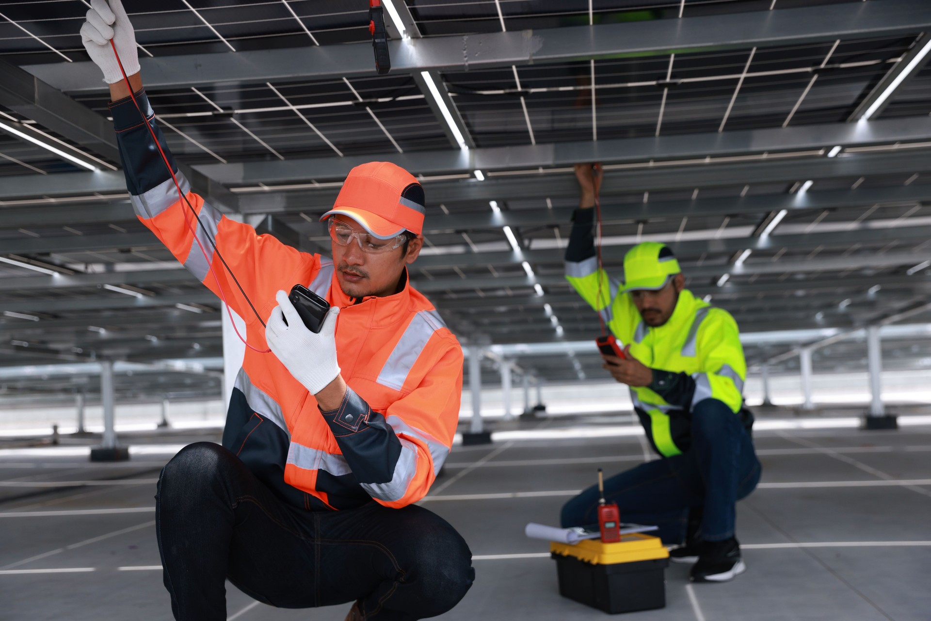 Solar engineer or electrical technician check amp and voltage and connect electrical wiring of solar panel and control unite, new technology alternative energy, sustainable energy investment