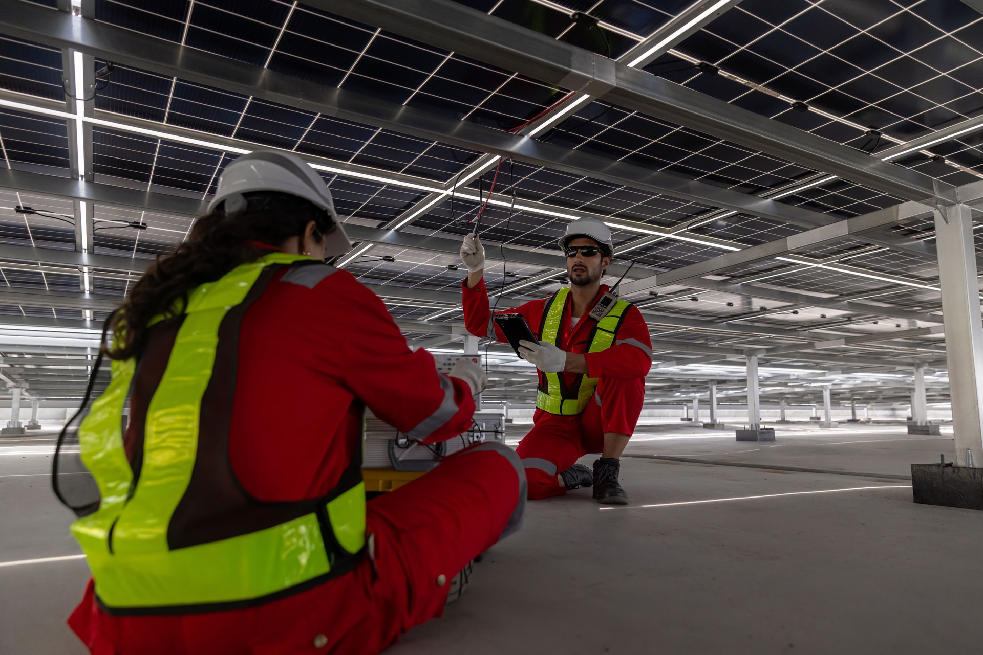 Engineer service check and Service solar cell on the roof of factory. Engineers walking on roof inspect and check solar cell panel. Engineer working inspection installation solar cell on the roof